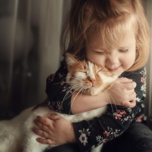cute little girl snuggling cute cat