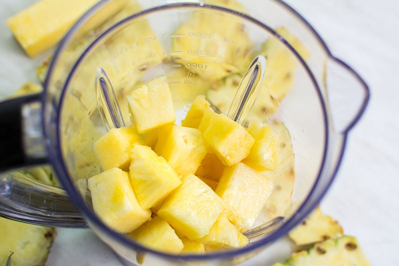 Sliced pineapple in a blender for making smoothie