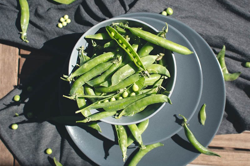 snap peas on a bowl