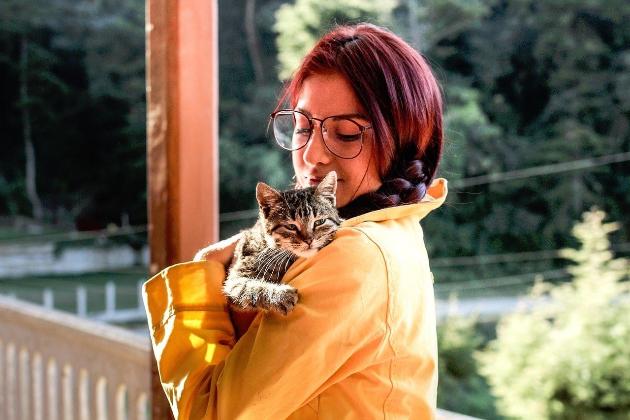 girl carrying a cat