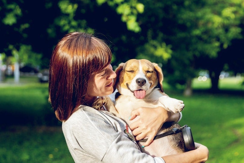 woman carrying an adorable dog