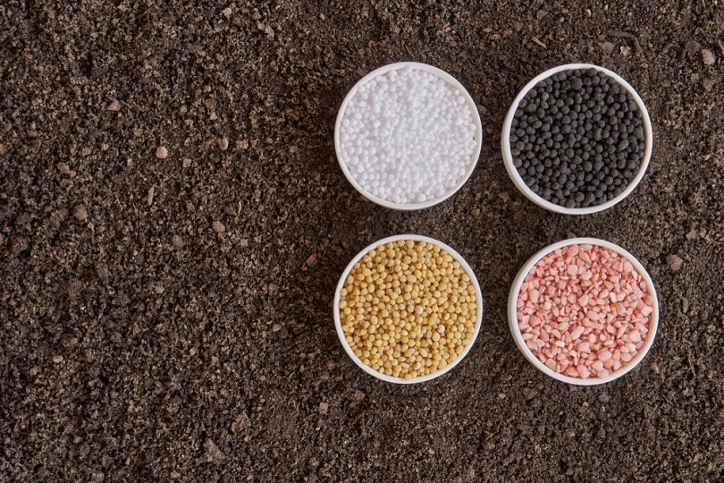 Chemical fertilizer on soil background