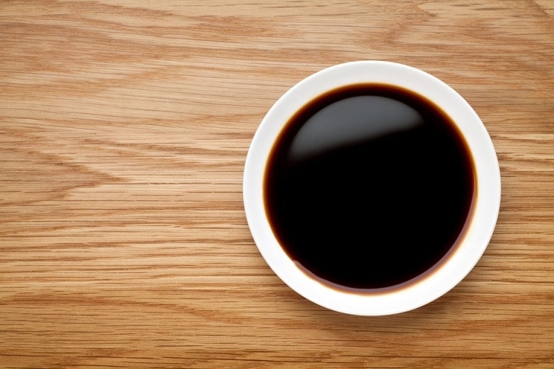 Dish of soy sauce on the wooden table