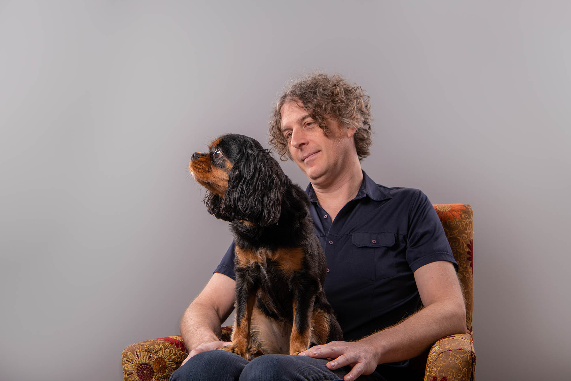 cavalier standing in man's lap