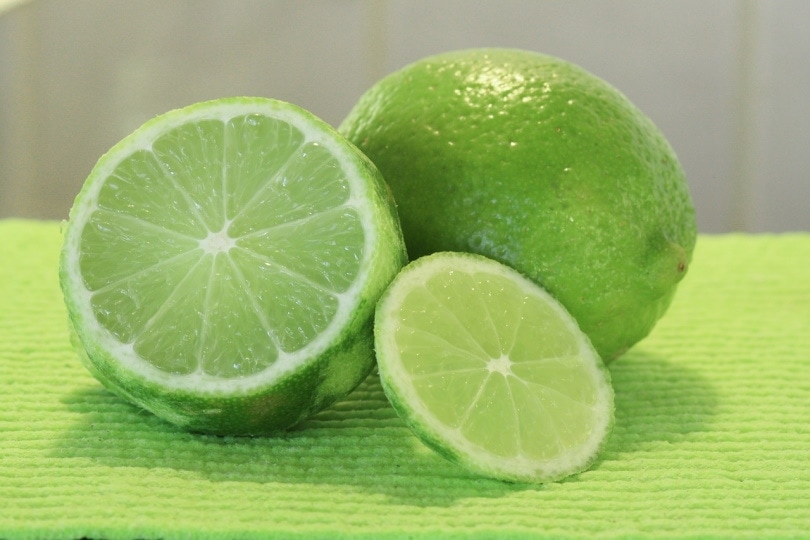 Limes placed on a green surface
