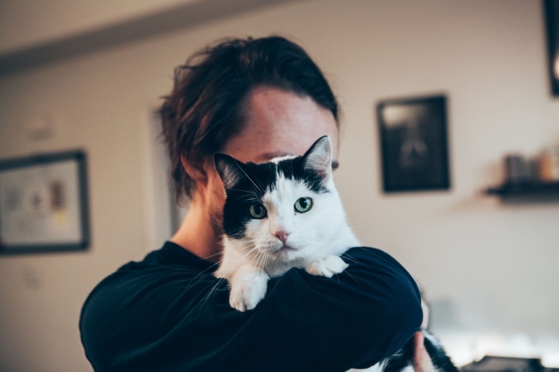 man holding cat