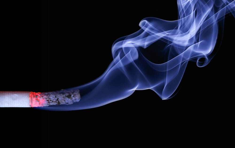 burning cigarette on black background