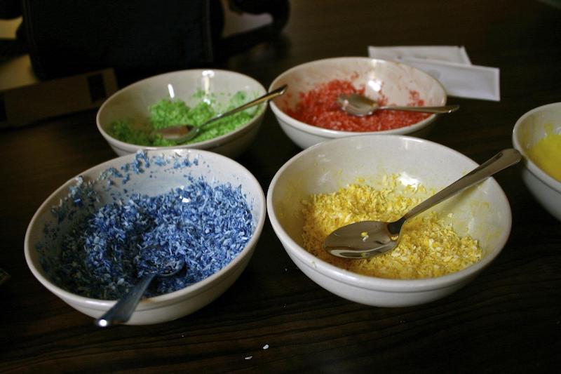 food coloring in bowls with spoons