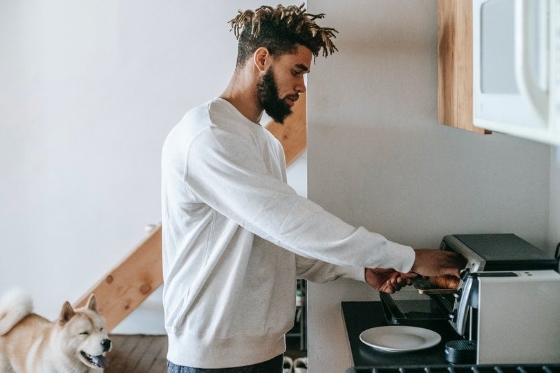 Man using microwave to heat dog food