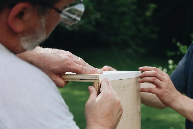 two people doing woodwork diy