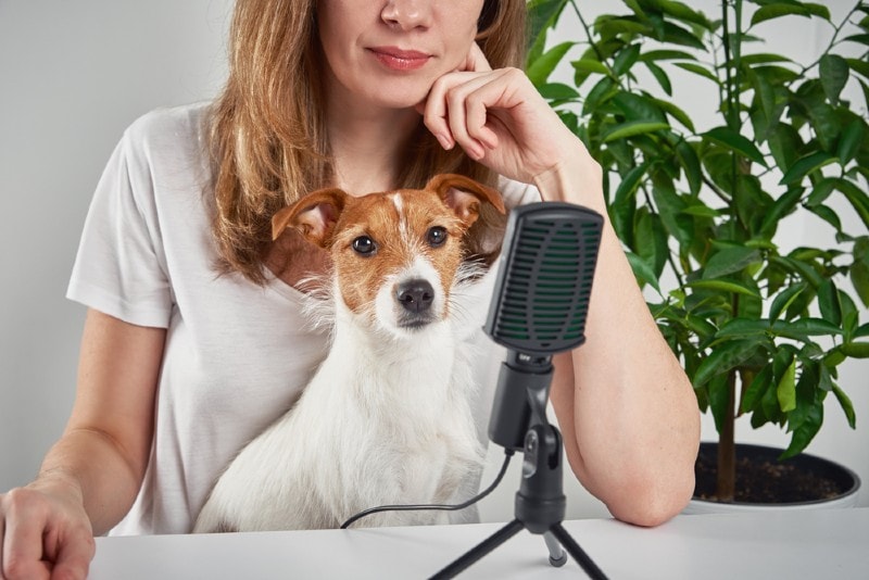 woman recording a podcat with her pet dog