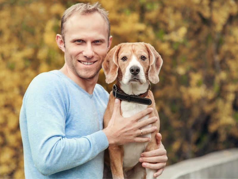 man holding beagle dog_Soloviova