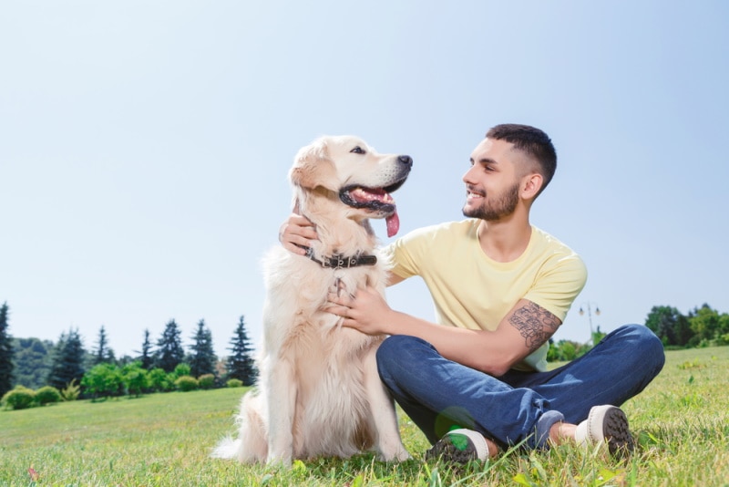 man with golden retriever