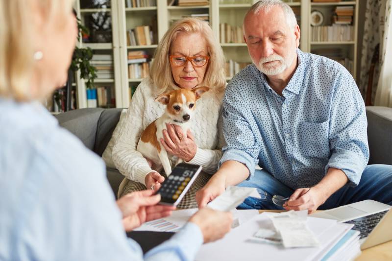 couple with a dog getting a pet insurance