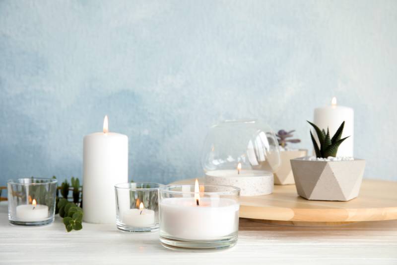 burning candles and aromatic plants on the table