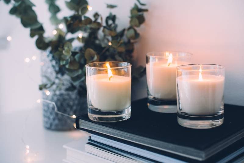 scented candles on top of books