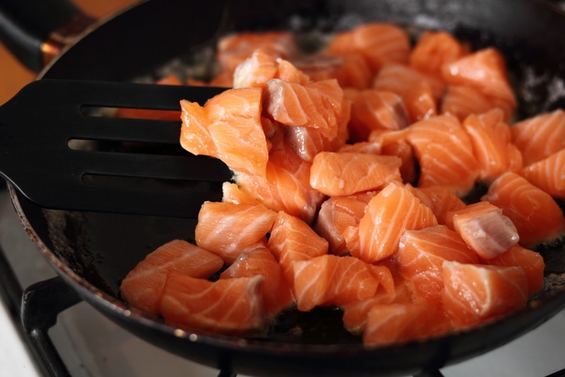 Diced salmon grilled in a skillet