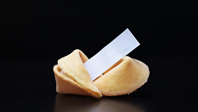a fortune cookie on black background