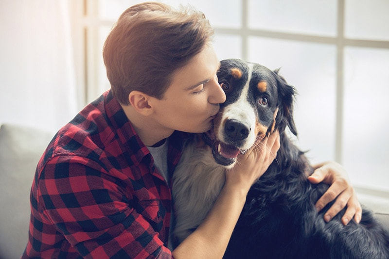 male owner hugging his dog
