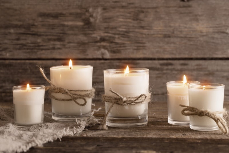 scented candles on wooden background