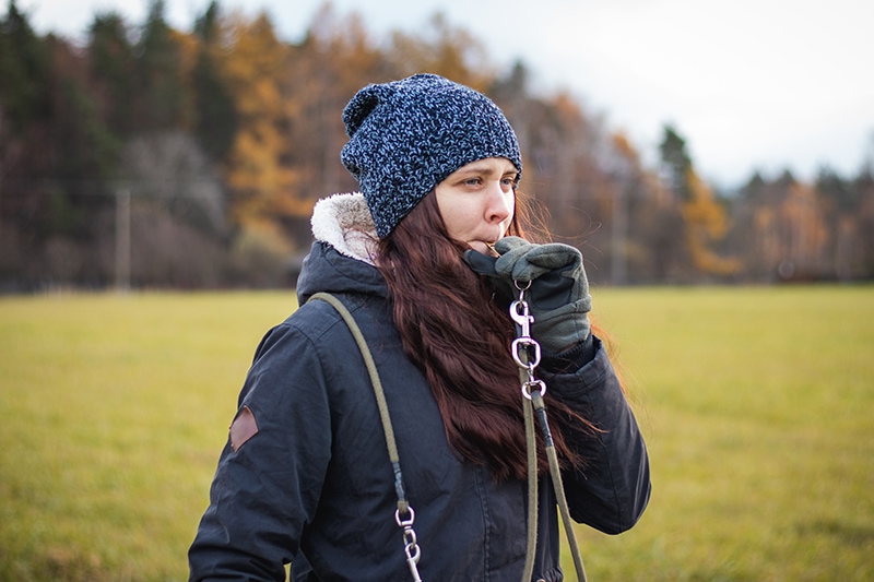 young woman using whistle