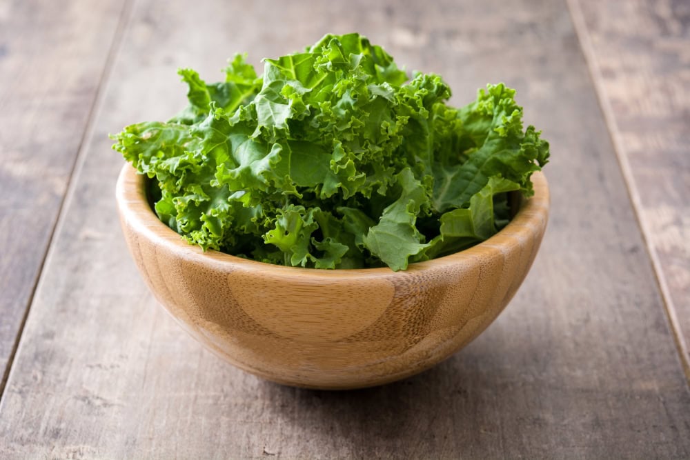 kale leaves in wooden bowl