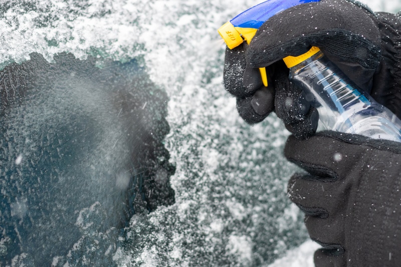 man spraying de-icer