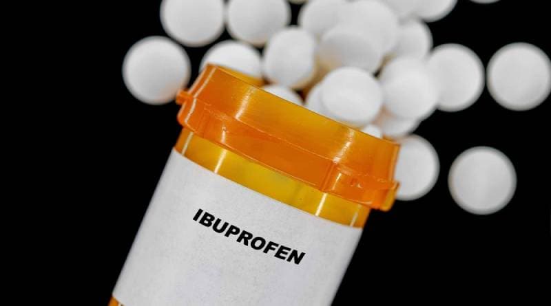 ibuprofen pills out of an orange plastic container