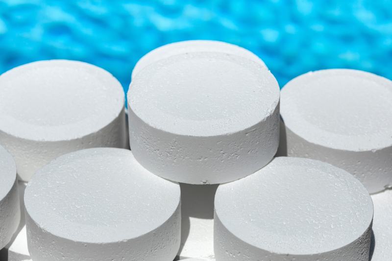 stacked white chlorine tablets for swimming pool