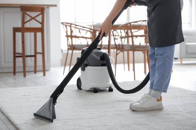 woman cleaning carpet
