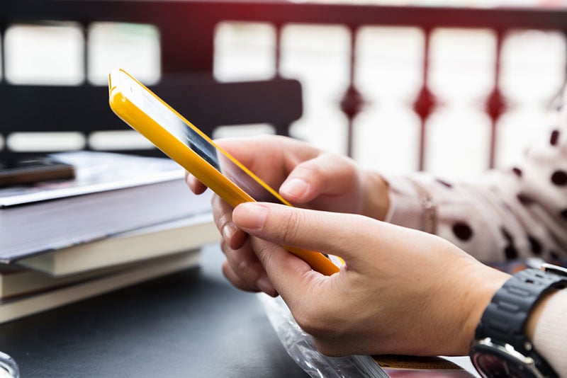 woman hands holding a smartphone
