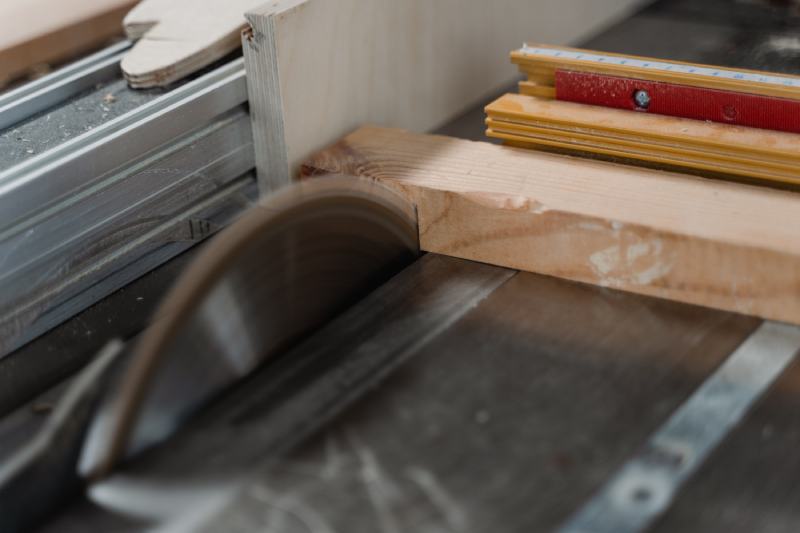 Close-Up Photo of Wood Getting Cut by a Table Saw
