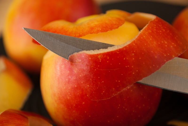 Peeling apple skin with a knife