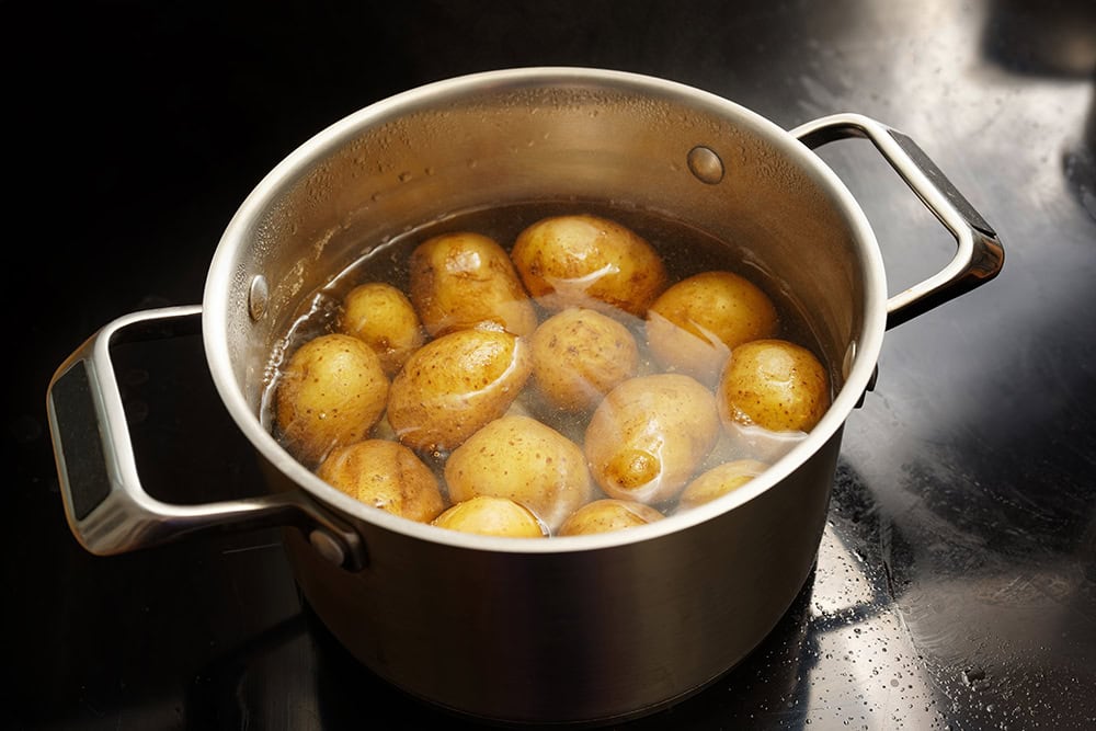 boiling potatoes in a steel pot