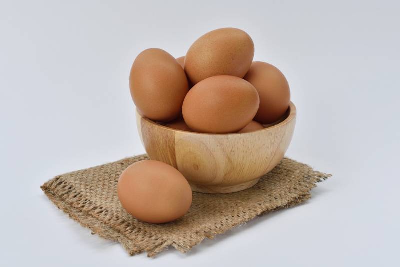 brown eggs in a wooden bowl