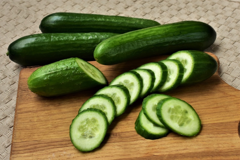 cucumbers on wooden board