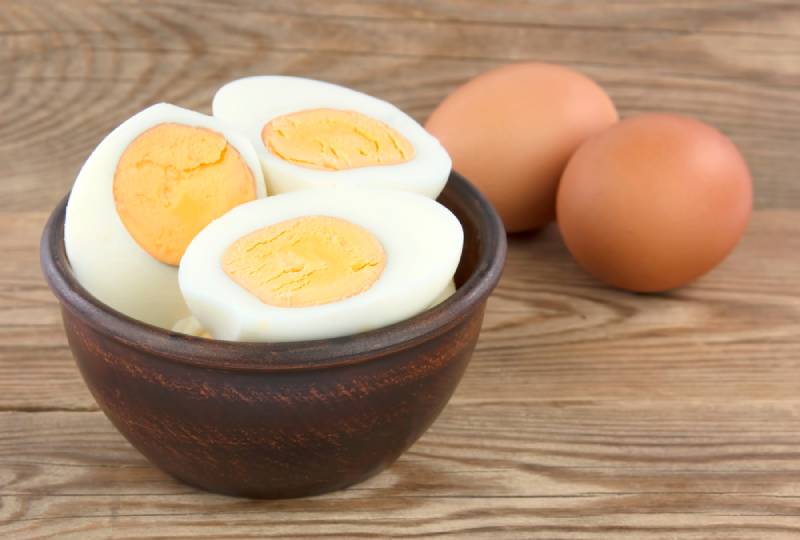 sliced boiled eggs on a wooden bowl