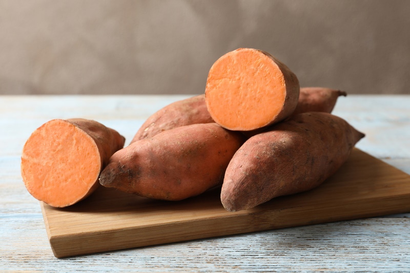 sweet potatoes in wooden board