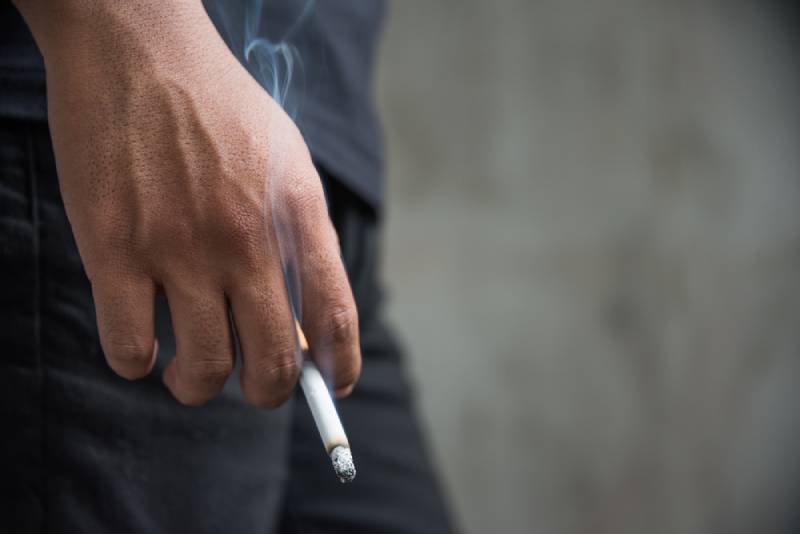 man holding a cigarette