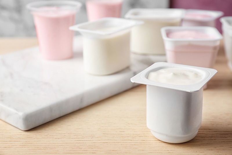 Plastic cup with tasty yogurt