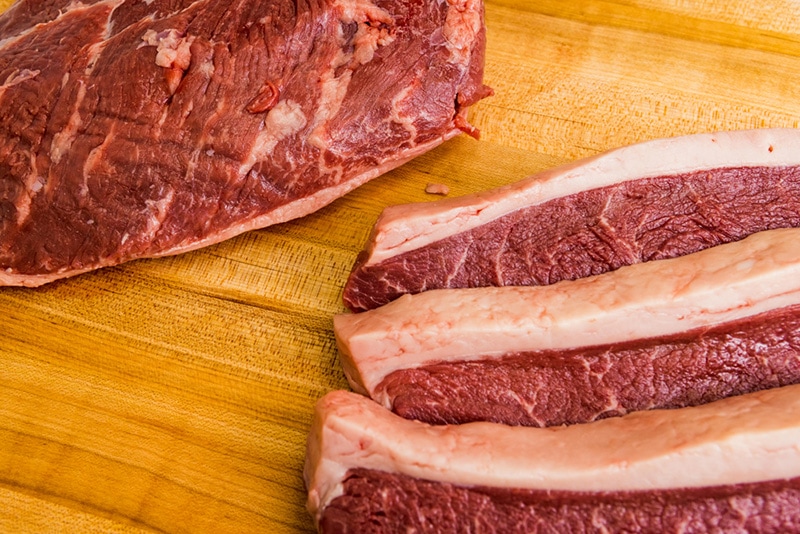 Raw meat plated on a wooden tablet