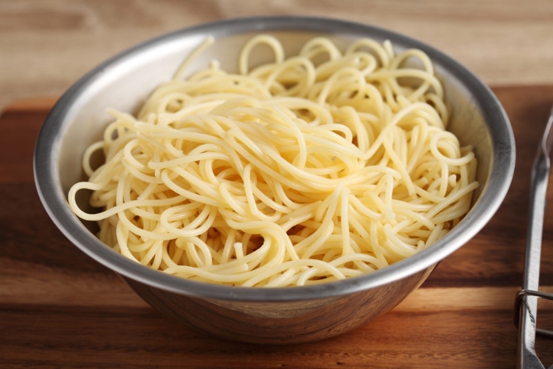 cooked spaghetti in metal bowl
