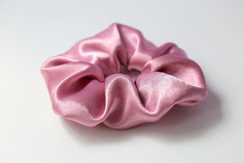 Pearl pink scrunchie on white background