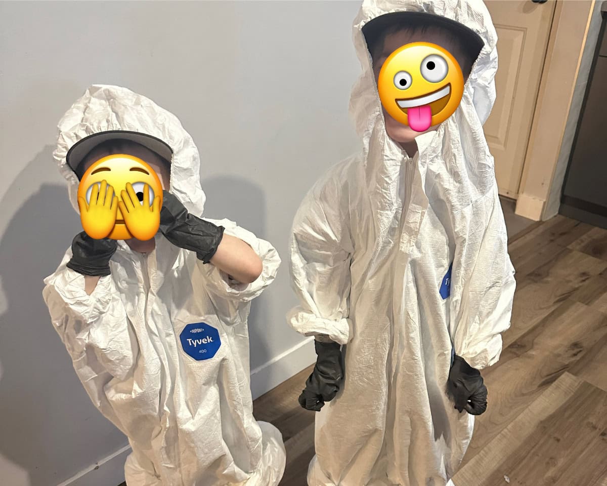 Amanda's sons dressed in their matching hazmat suits