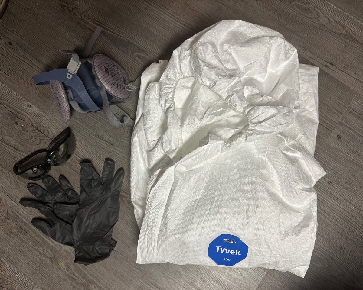 mask, rubber gloves, safety glasses, and hazmat suit