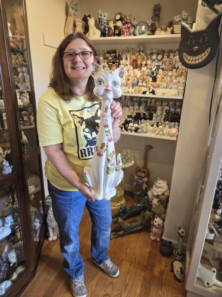 Hilary holding the 3-feet-tall ceramic cat from 1964